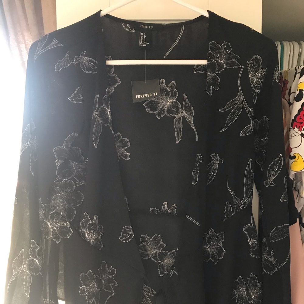 A wrap style long sleeve black & white shirt